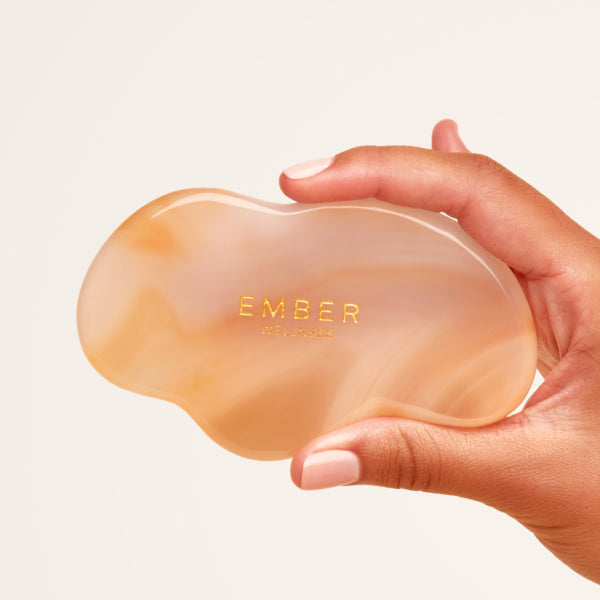 Our patented Cloud Gua Sha tool designed to hug every curve on the body, seen here in agate.