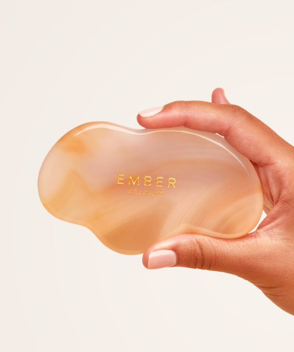 Our patented Cloud Gua Sha tool designed to hug every curve on the body, seen here in agate.